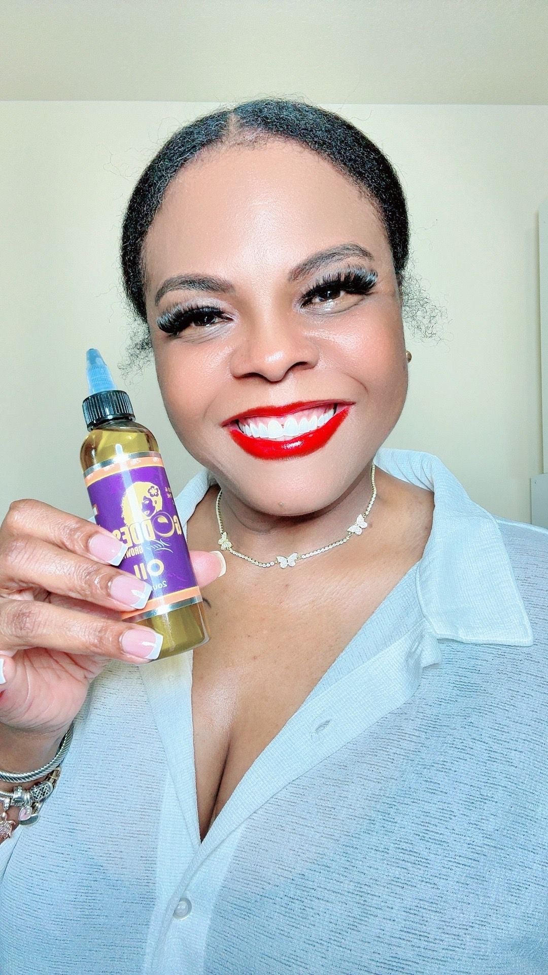 Woman holding a bottle of 'Bella Ciao' product with a plain background